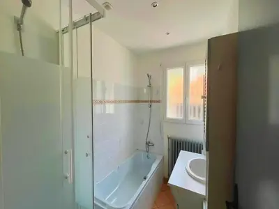 a white bathroom with a tub and a sink at Villa in St Denis with Pool & Pyrenees View in Saint-Denis
