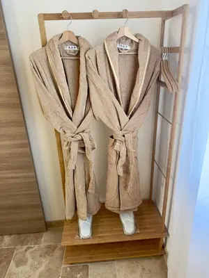 a rack with robe and shoes hanging in a room at L'étoile de Preixan in Preixan