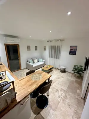 a living room with a table and a couch at L'étoile de Preixan in Preixan