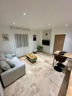 a living room with a couch and a table at L'étoile de Preixan in Preixan