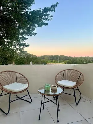 two chairs and a table on a patio at L'étoile de Preixan in Preixan