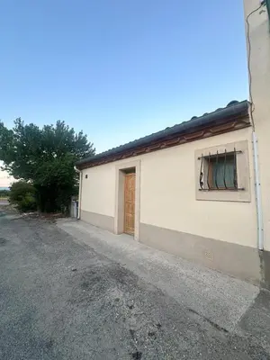 a white building with a window and a door at L'étoile de Preixan in Preixan