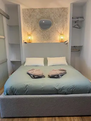 a bed in a room with two pillows on it at Maisonnette Proche Gare & Centre l Jardin l Clim in Castres