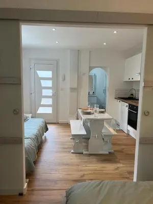 a kitchen with two beds and a table in a room at Maisonnette Proche Gare & Centre l Jardin l Clim in Castres