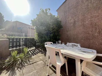 a white table and chairs sitting on a patio at Proche plage du Grazel, Pavillon avec piscine - GN530-008 in Gruissan