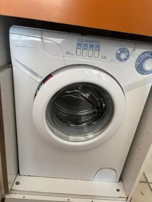 a white washing machine sitting in a room at T2 traversant, 2 balcons, 4 pers, proche plage in Port-la-Nouvelle