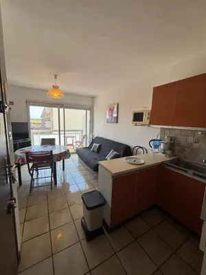 a kitchen and living room with a couch and a table at T2 traversant, 2 balcons, 4 pers, proche plage in Port-la-Nouvelle