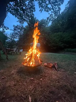 a fire pit in a field with flames at Domaine du Fourtet in Arfons