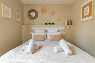 a bedroom with a large white bed with white pillows at Plein centre - climatisé - à proximité cité médiévale in Carcassonne