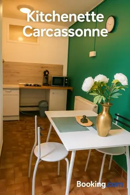 a white table and chairs with a vase of flowers at Carcassonne Studio in Carcassonne