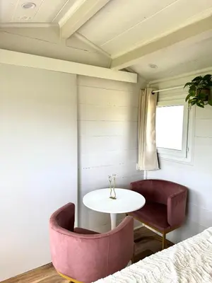 a room with two chairs and a table and a window at La paillote , confort toutes saisons in Moussan