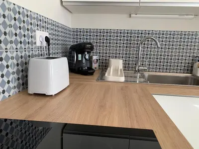 a kitchen counter with a toaster on top of it at Nusa in Narbonne