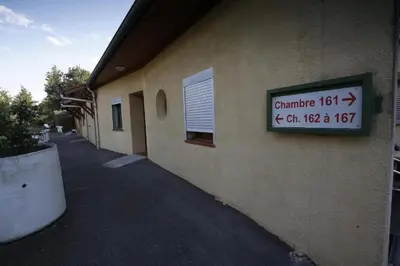 a sign on the side of a building at Rocade capsule bungalow in Pamiers