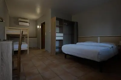 a bedroom with two beds in a room with at Rocade capsule bungalow in Pamiers
