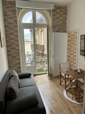 a living room with a couch and a table at Appartement Moderne au centre de NARBONNE in Narbonne