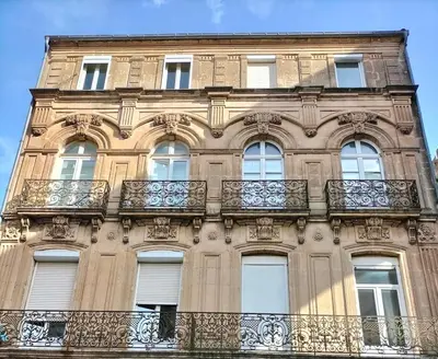a tall building with balconies on the side of it at Appartement Moderne au centre de NARBONNE in Narbonne