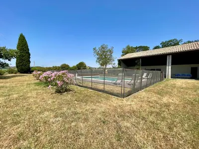 a fence in front of a yard with a swimming pool at Le Gîte de Barrau in Fenouillet-du-Razès
