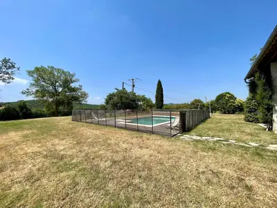 a backyard with a swimming pool and a fence at Le Gîte de Barrau in Fenouillet-du-Razès