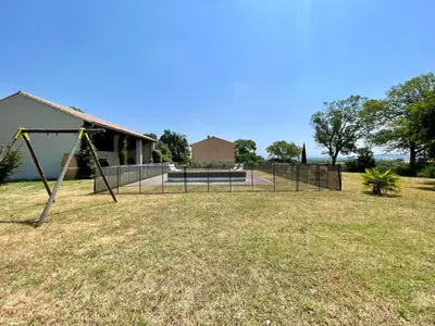 a park with a swing set in the grass at Le Gîte de Barrau in Fenouillet-du-Razès