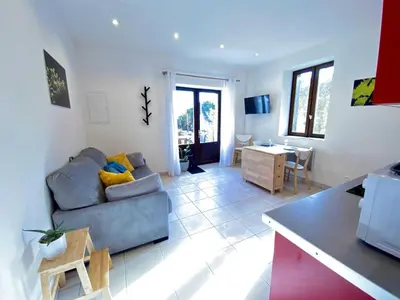a living room with a couch and a table at Gite du domaine de Couchalou in Fontjoncouse