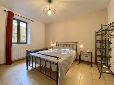 a bedroom with a bed and a window at Gite du domaine de Couchalou in Fontjoncouse