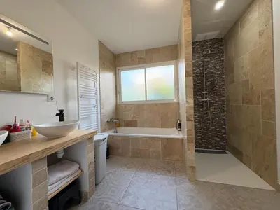 a bathroom with a tub and a sink and a shower at Maison piscine vue Cité Carcassonne in Carcassonne