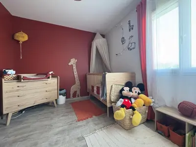 a childs room with a crib with stuffed animals at Maison piscine vue Cité Carcassonne in Carcassonne