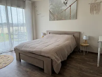 a bedroom with a bed and a large window at Maison piscine vue Cité Carcassonne in Carcassonne