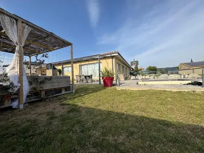 a house with a tent and a grass yard at Maison piscine vue Cité Carcassonne in Carcassonne