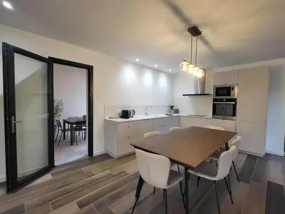 a kitchen and dining room with a table and chairs at Villa neuve calme - piscine privée - vue sur les vignes in Roquecourbe-Minervois
