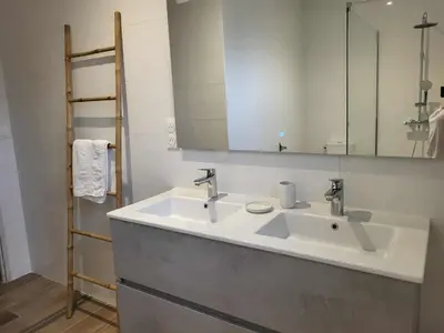 a bathroom with a sink and a mirror at Villa neuve calme - piscine privée - vue sur les vignes in Roquecourbe-Minervois