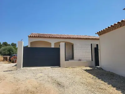 a garage door in front of a house at Villa neuve calme - piscine privée - vue sur les vignes in Roquecourbe-Minervois