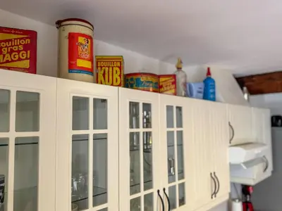 a kitchen with white cabinets and food items on top of it at Evasion Vintage à Estagel - 4 pers - Terrasse in Estagel