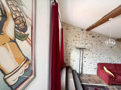 a staircase in a room with a painting on the wall at Evasion Vintage à Estagel - 4 pers - Terrasse in Estagel