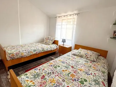 a bedroom with two beds and a window at Evasion Vintage à Estagel - 4 pers - Terrasse in Estagel