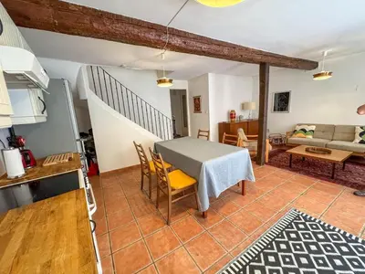 a kitchen and living room with a table and chairs at Evasion Vintage à Estagel - 4 pers - Terrasse in Estagel