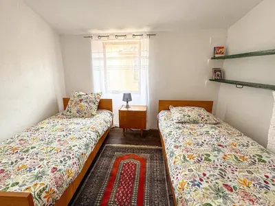 a bedroom with two beds and a window at Evasion Vintage à Estagel - 4 pers - Terrasse in Estagel