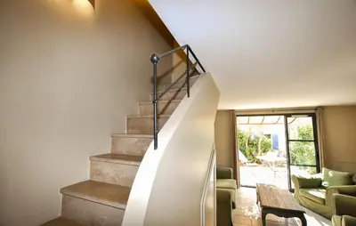 a spiral staircase in a house with a living room at 2 Bedroom Gorgeous Home In St-Laurent-De-La-Cabr in Saint-Laurent-de-la-Cabrerisse