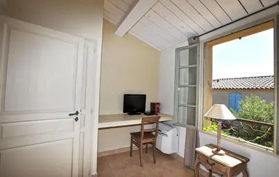 a room with a desk with a television and a window at 2 Bedroom Gorgeous Home In St-Laurent-De-La-Cabr in Saint-Laurent-de-la-Cabrerisse