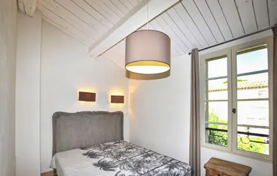a bedroom with a bed and a large window at 2 Bedroom Gorgeous Home In St-Laurent-De-La-Cabr in Saint-Laurent-de-la-Cabrerisse