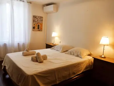 a bedroom with a large bed with two towels on it at Very Chic Townhouse with Pool and Garage in Carcassonne