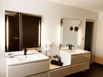 a bathroom with two sinks and a large mirror at Very Chic Townhouse with Pool and Garage in Carcassonne