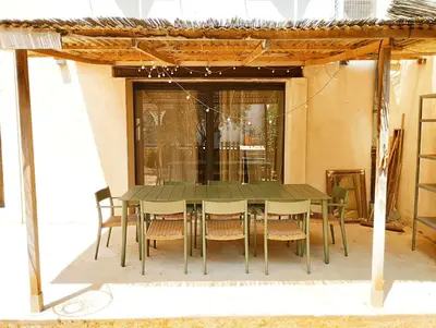 a green table and chairs on a patio at Very Chic Townhouse with Pool and Garage in Carcassonne