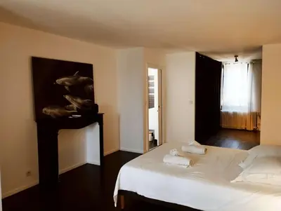 a bedroom with a bed and a painting on the wall at Very Chic Townhouse with Pool and Garage in Carcassonne