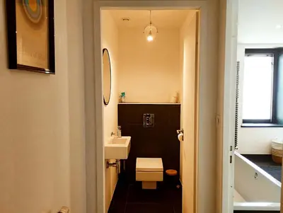 a small bathroom with a sink and a toilet at Very Chic Townhouse with Pool and Garage in Carcassonne