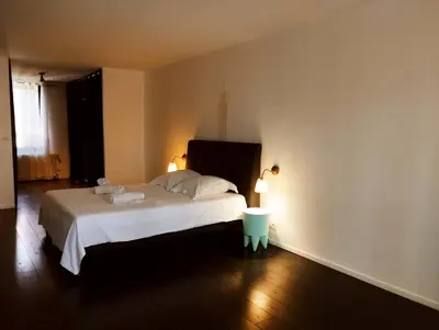 a bedroom with a large white bed with two lamps at Very Chic Townhouse with Pool and Garage in Carcassonne