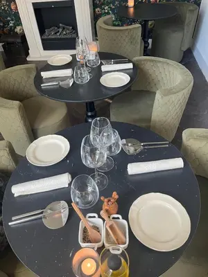 a black table with plates and wine glasses on it at Domaine du BaRon in Alzonne
