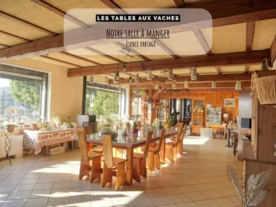 a large dining room with a table and chairs at Les Tables Aux Vaches à la Salvetat in La Salvetat