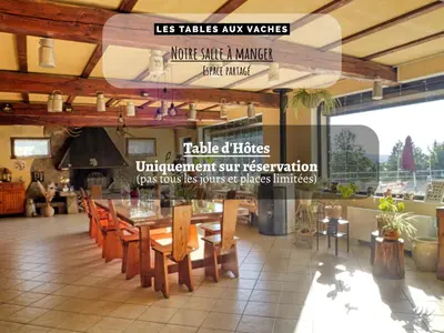 a bedroom with a bed with a wooden wall at Les Tables Aux Vaches à la Salvetat in La Salvetat
