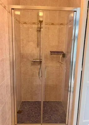a shower with a glass door in a bathroom at Suite Bleuet in Peyriac-de-Mer